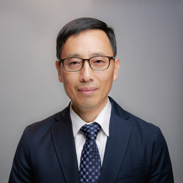 Dr. Charles Kim headshot on a gray background
